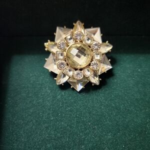 Vintage rhinestone star brooch features crystals set in gold-tone metal base